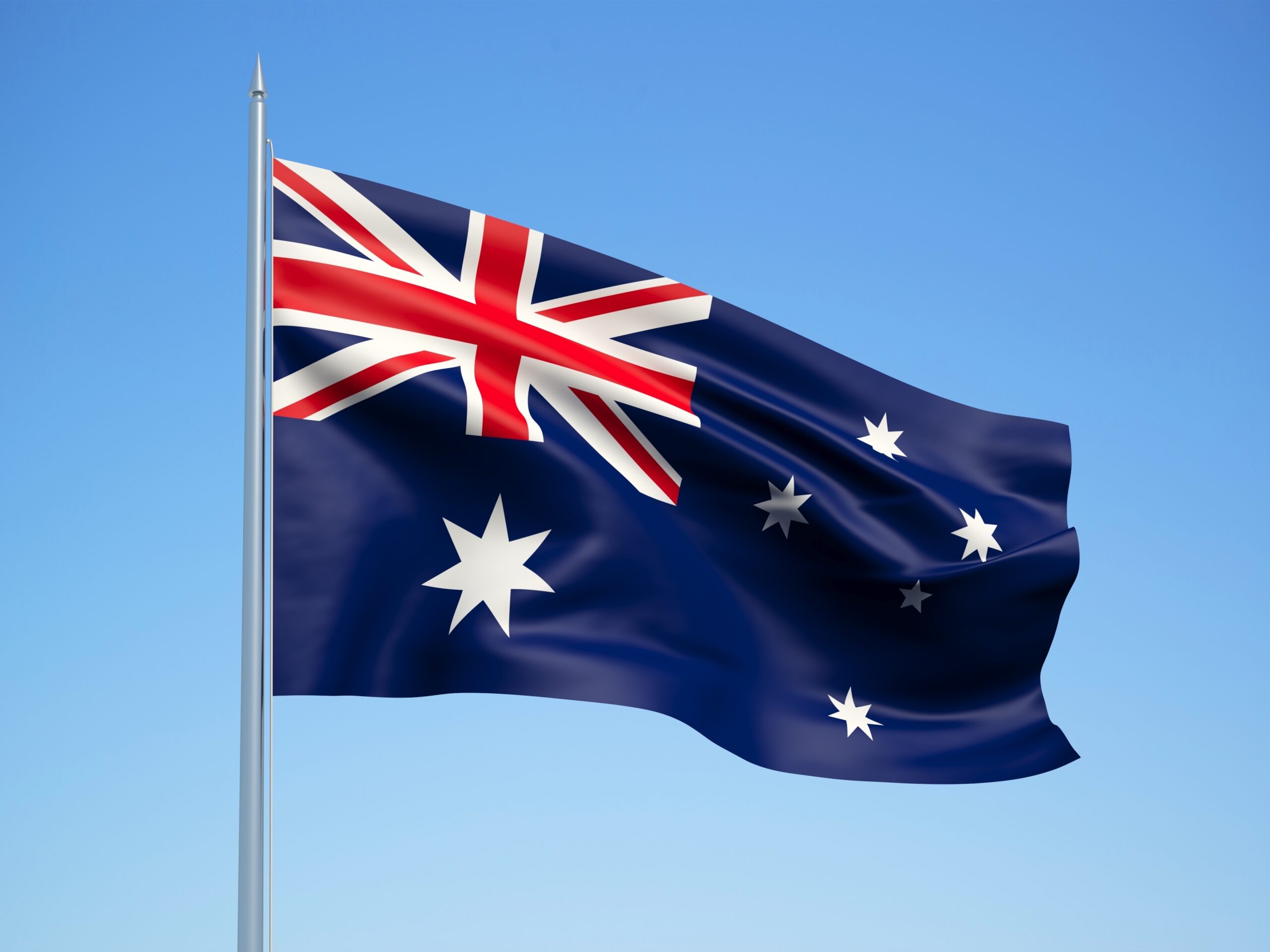 Australia 3d flag floating in the wind with a blue sky background