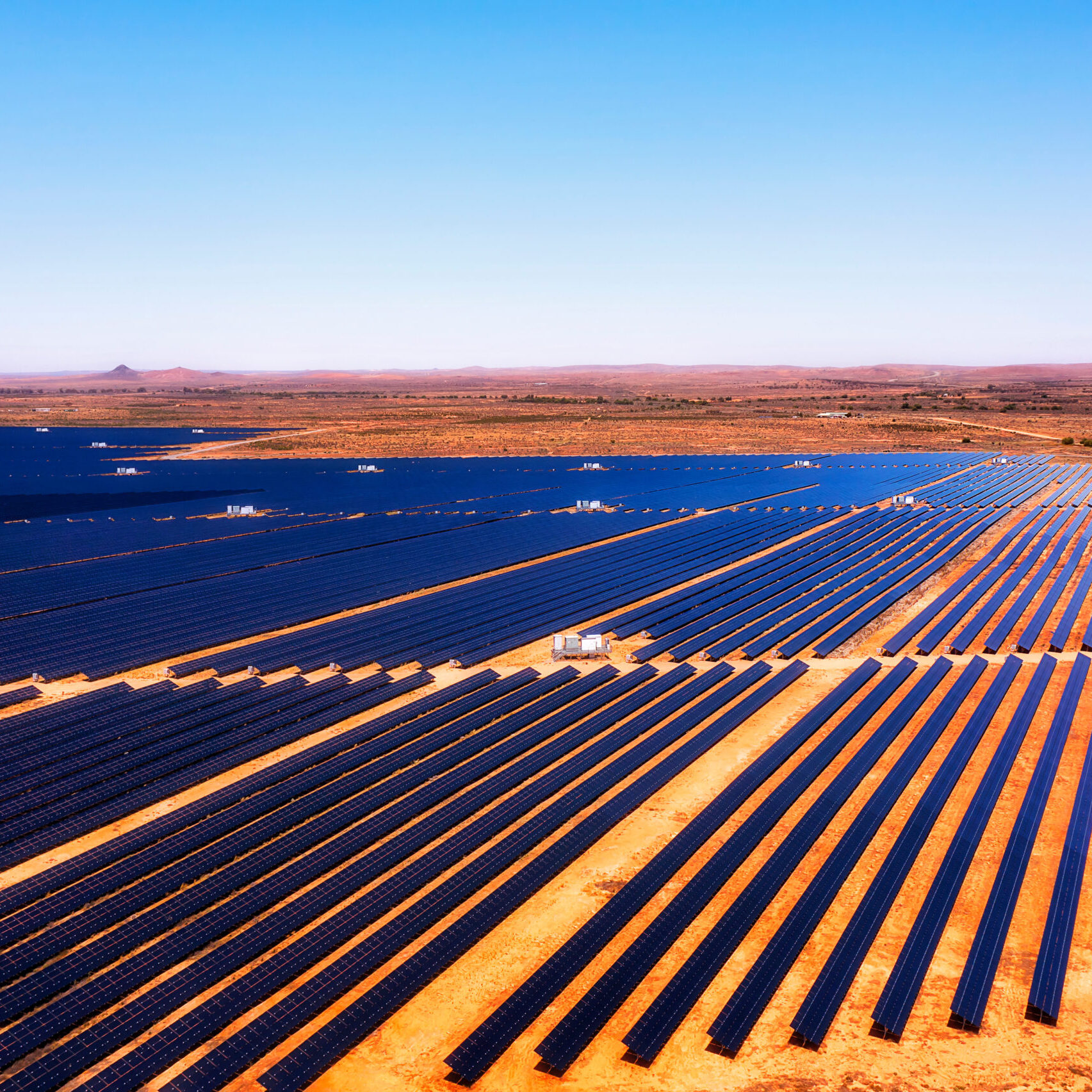 Broken hill solar farm on endless plains of red soil outback of Australia - aerial industrial landscape.